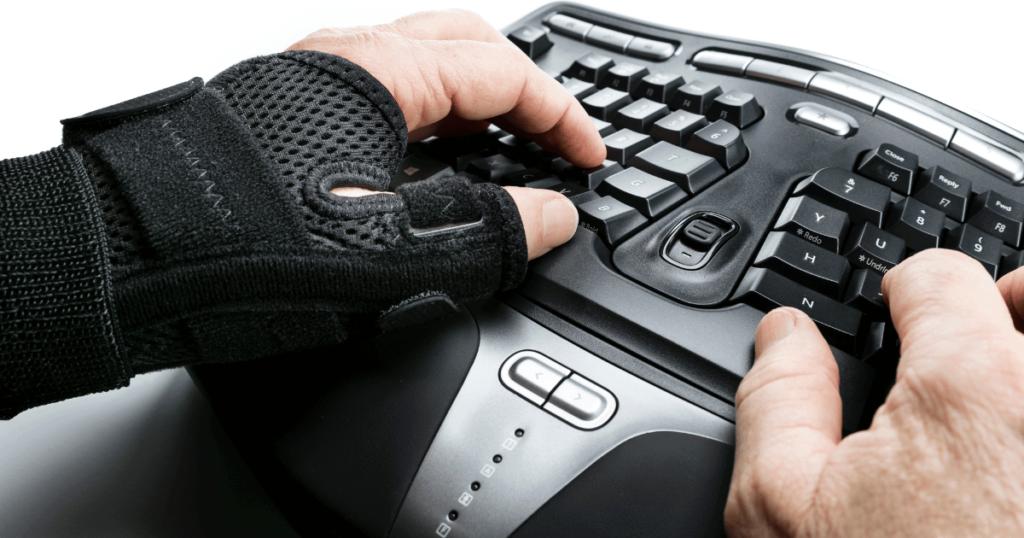 A man using a wrist brace for typing